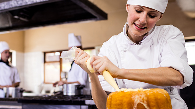 Chef de Partie Chef de Partie icing a cake